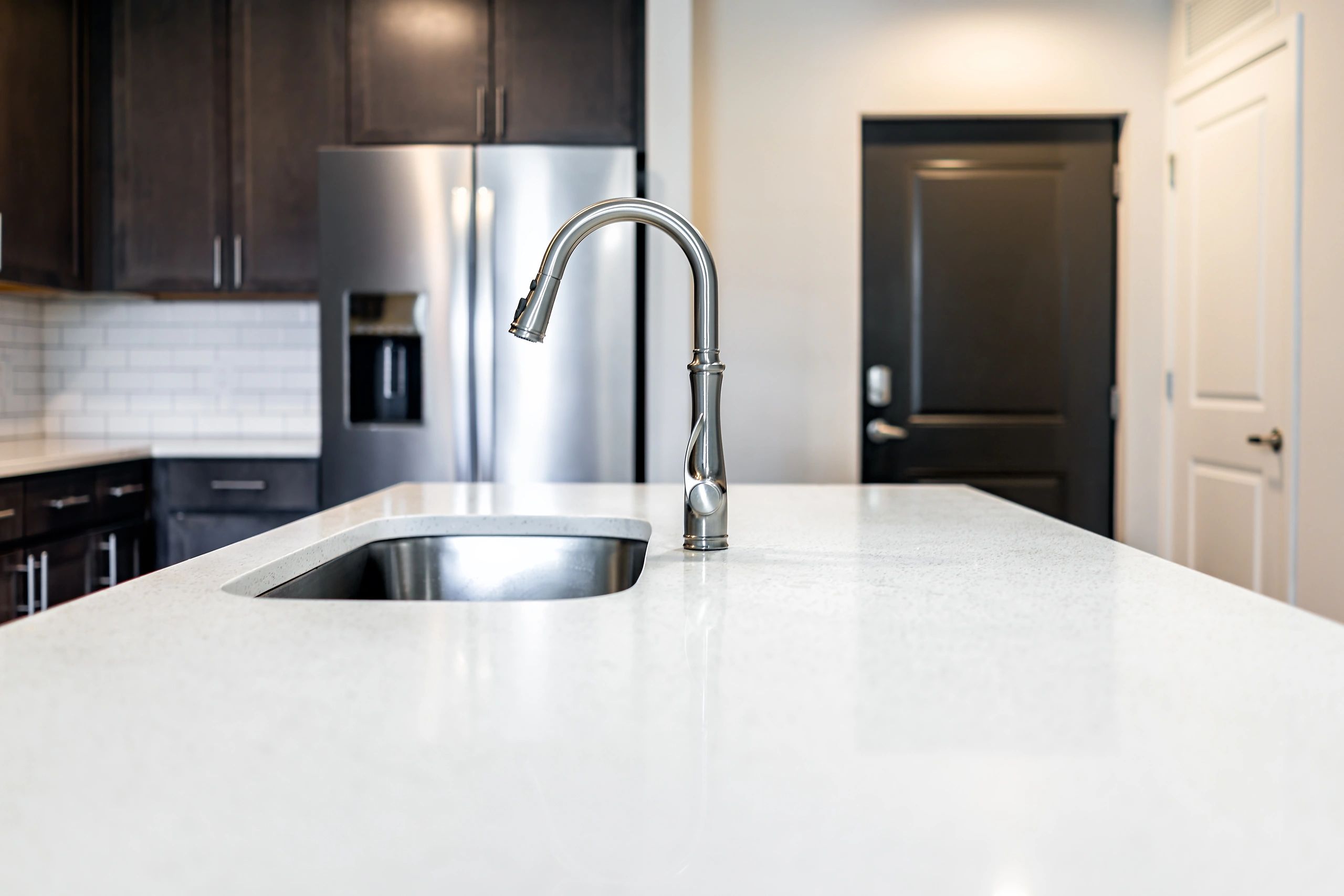 Quartz countertop island in a bright modern kitchen with clean lines