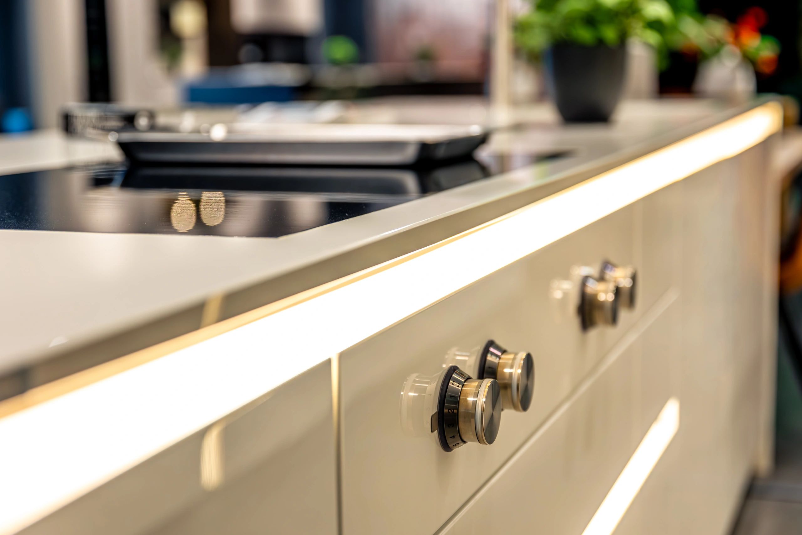 High-end white and cream quartz kitchen island in a bright luxury kitchen